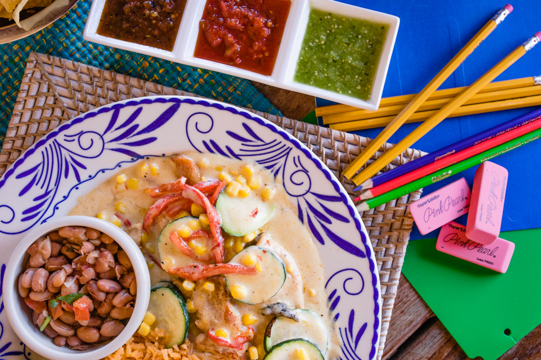 Various pencils and erasers next to Pechuga con Calabaza