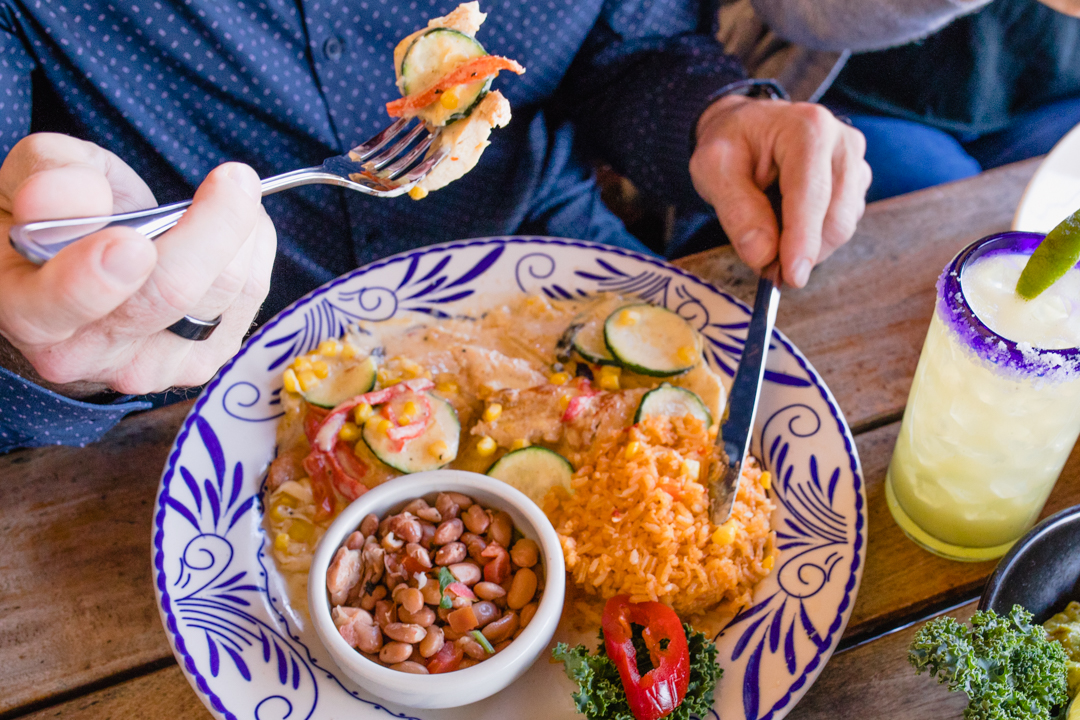 Overhead shot of Abuelo's guest enjoying our Pechuga con Calabaza